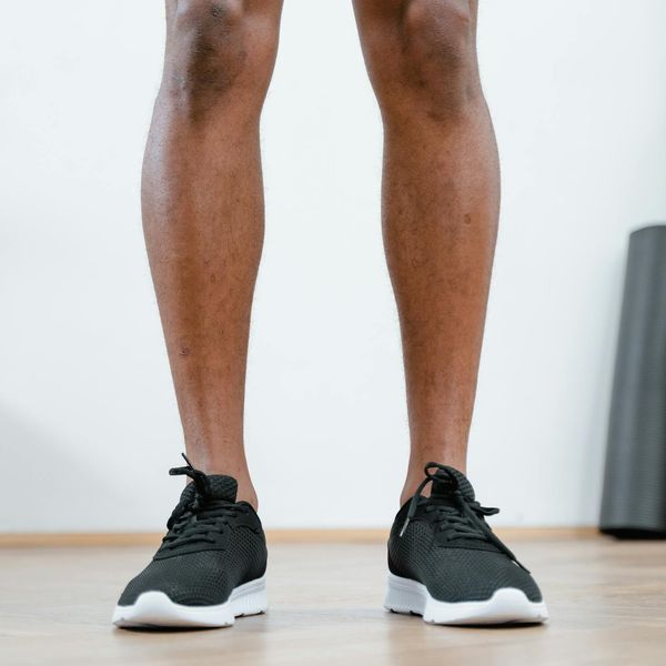Close-up of a person's running shoes on a clean floor.
