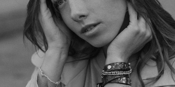 Silhouette of a person in a powerful stance against a minimal background.